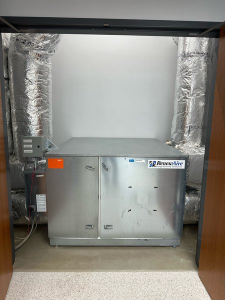 RenewAire energy recovery ventilator installed in a mechanical closet with insulated ductwork